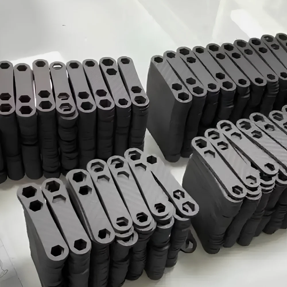 Batch of small machined carbon fiber link parts