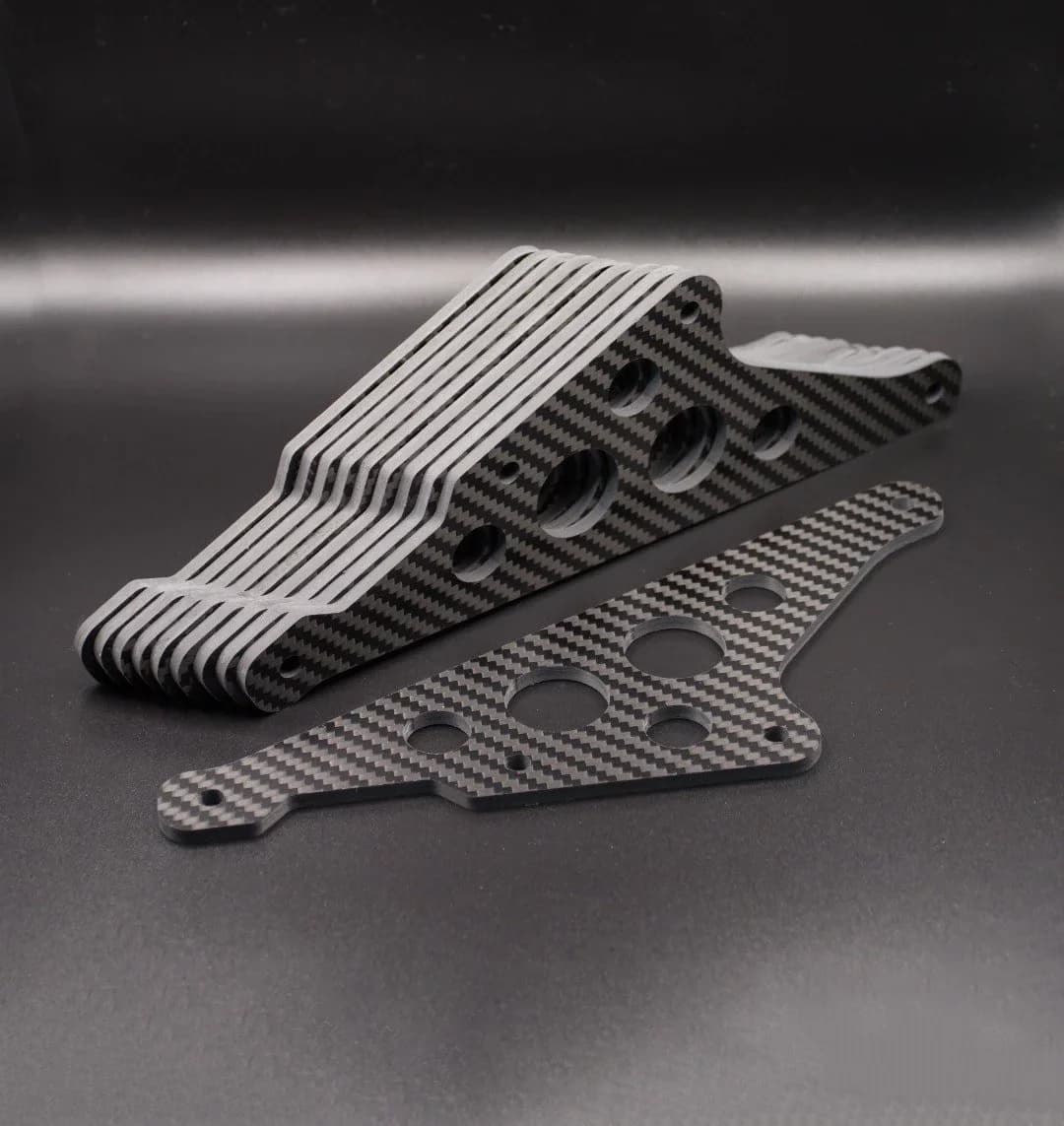 Stacked machined carbon fiber parts prepared for batch production