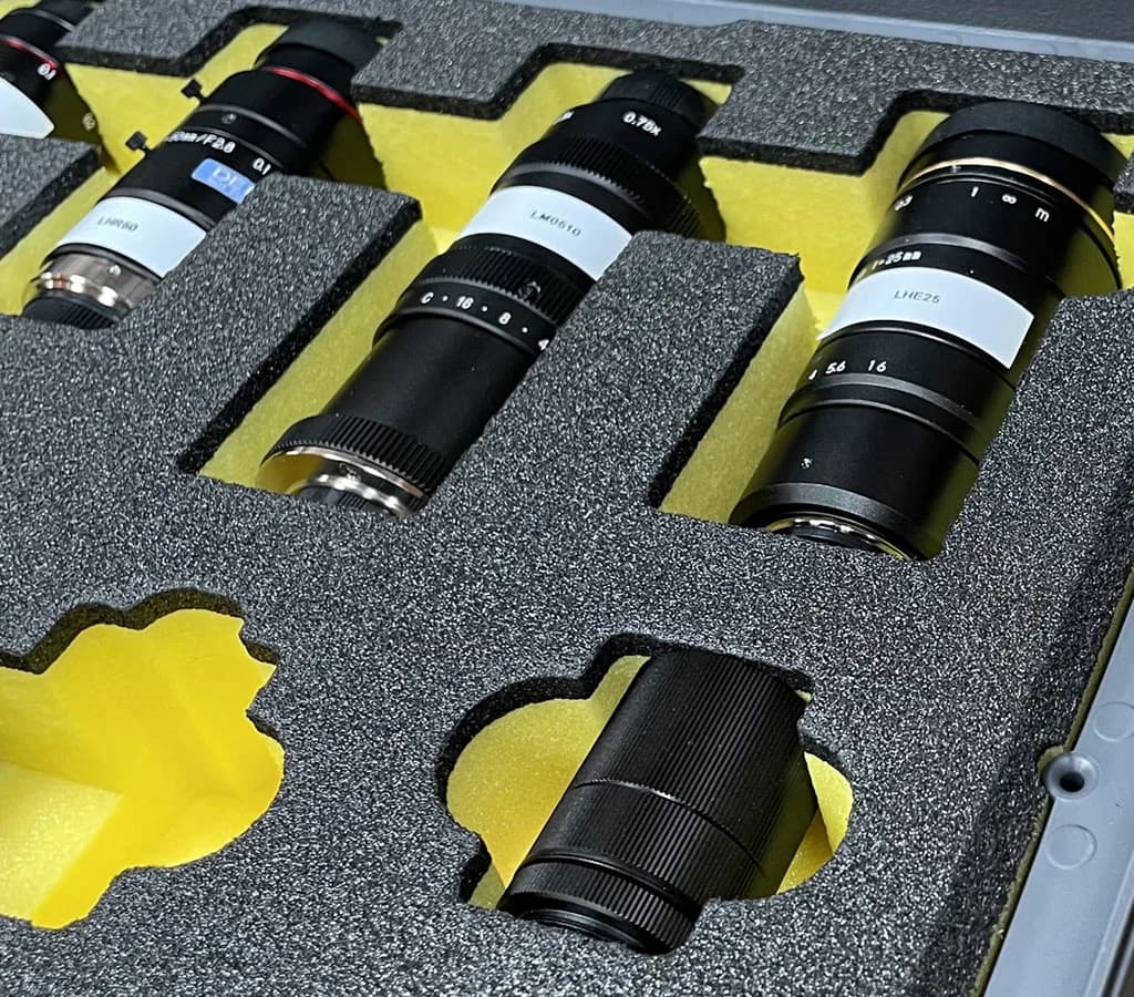 Camera lenses organized in custom cut foam
