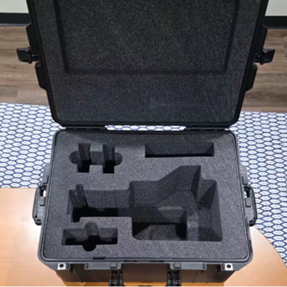 Open hard case with custom cut black foam cavities