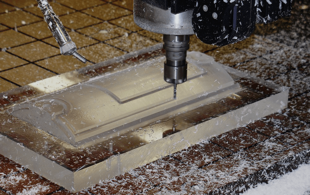 CNC machine cutting a clear plastic component