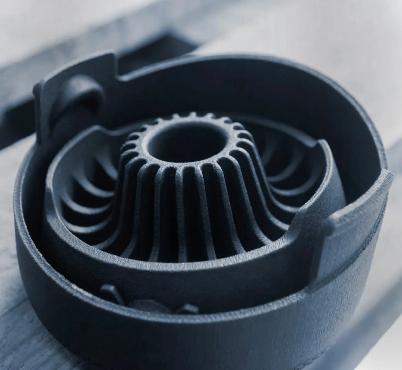 Black plastic component with smooth curved ribs