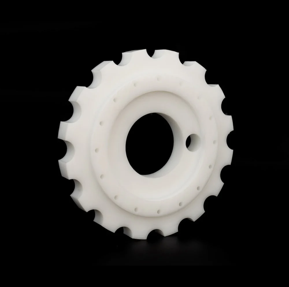 White precision-machined plastic sprocket component